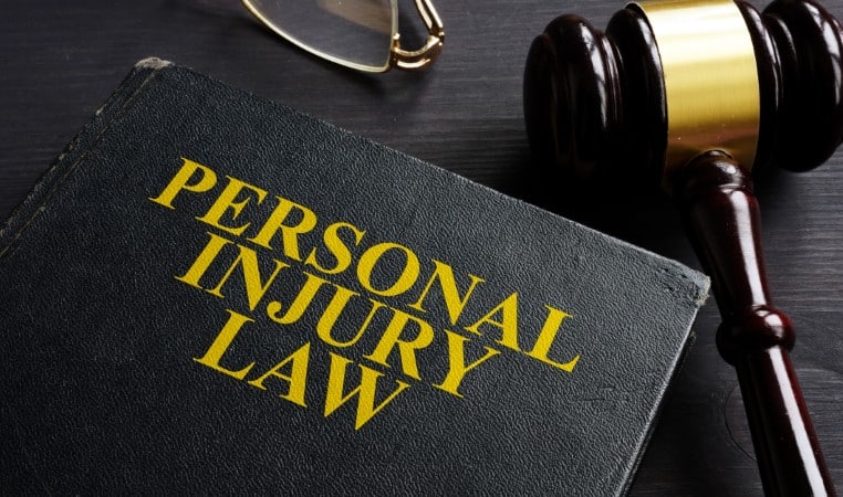 Personal Injury Law book and a black desk.