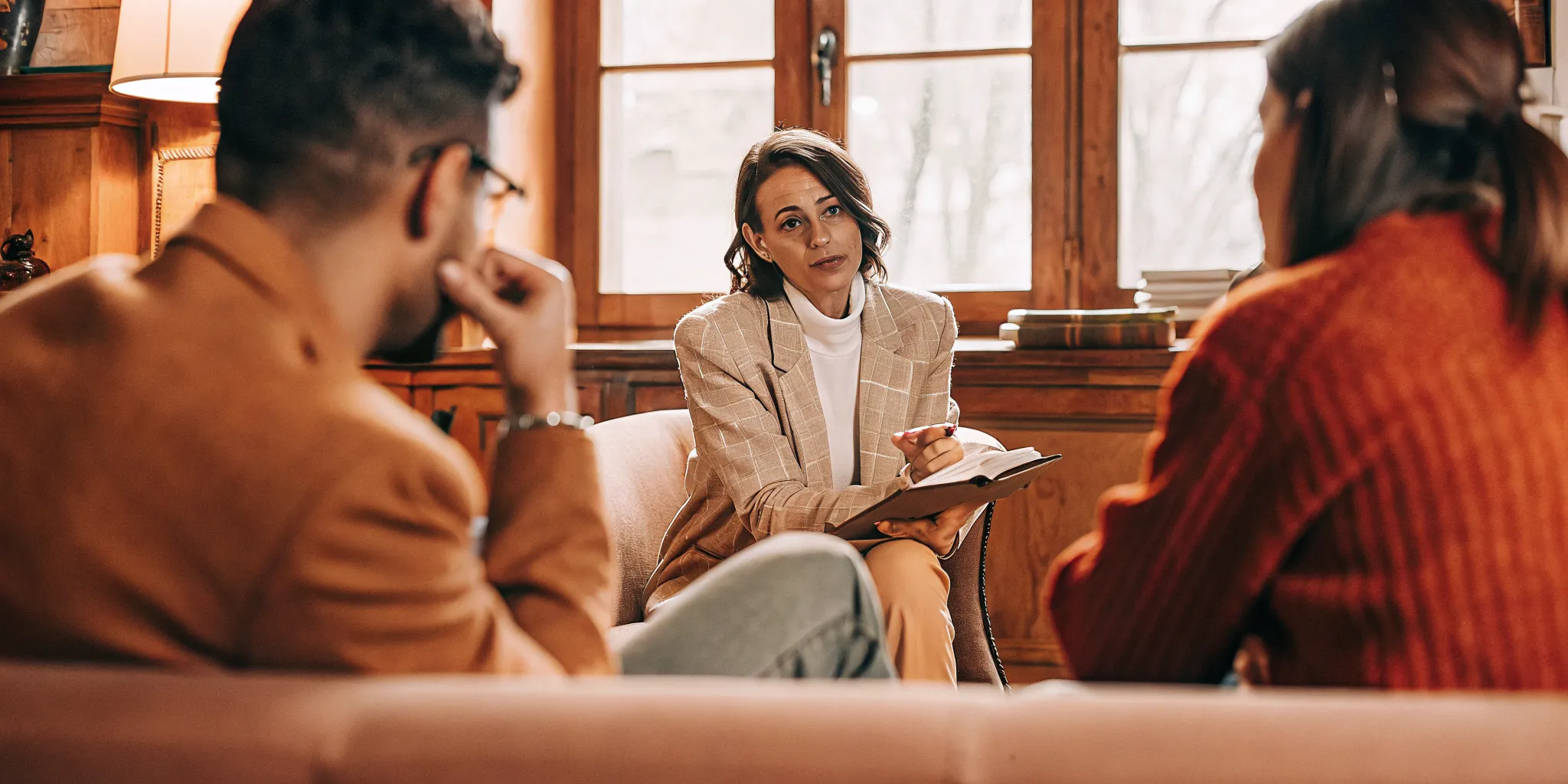 Compassionate attorney meeting with grieving family in a warm South Carolina law office
